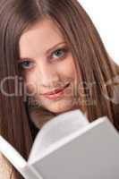 Portrait of young happy woman with book