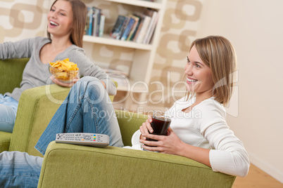 Students - Two smiling female teenager watching television toget