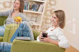 Students - Two smiling female teenager watching television toget
