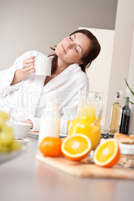 Young woman enjoying coffee in kitchen