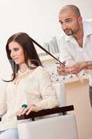 Professional hairdresser cut with scissors at salon