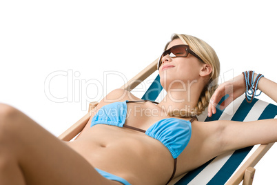 Beach - Young woman in bikini lying on deck chair