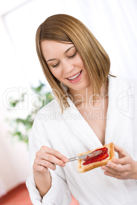 Breakfast - Happy woman with toast and marmalade