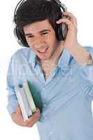 Male student with headphones holding books