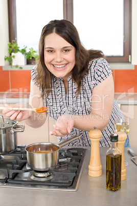 Cook - plus size woman tasting Italian tomato sauce