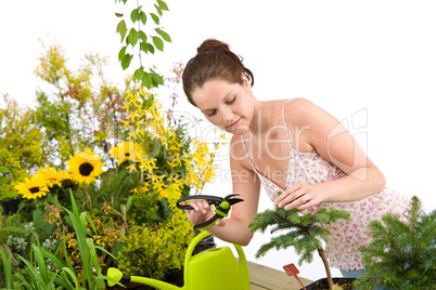 Gardening - woman cutting tree with pruning shears