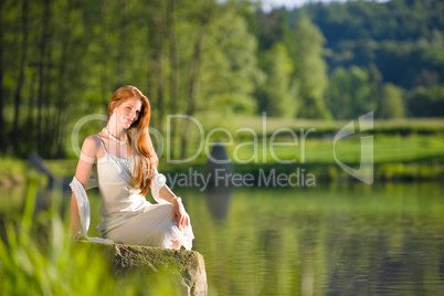 Long red hair romantic woman relax by lake