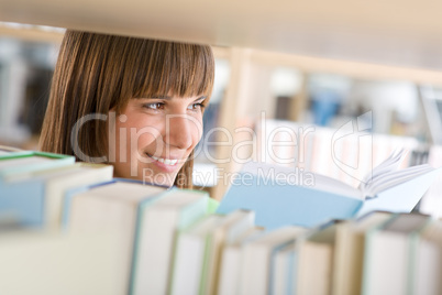 Student in library - happy woman study from book
