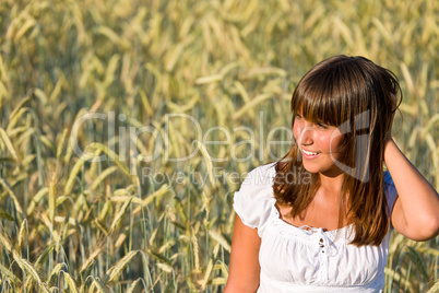 Young woman in corn field enjoy sunset