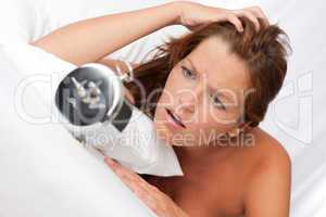 White lounge - Shocked woman watching alarm clock