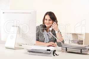 Attractive secretary on phone at office