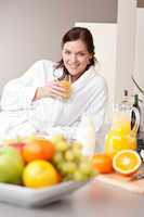 Young woman drink orange juice for breakfast in kitchen