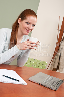 Long red hair woman at office with coffee