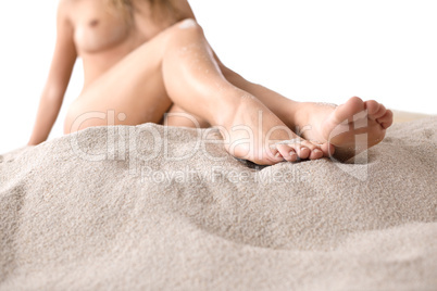 Naked woman sunbathing on beach