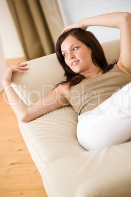 Young woman relax lying down on sofa