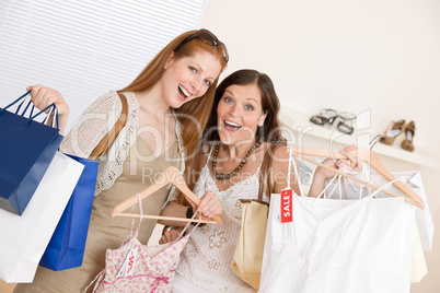 Fashion shopping -  Two happy young woman choose clothes