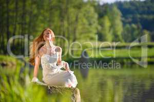 Long red hair romantic woman relax by lake