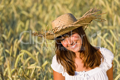 Happy woman with straw hat in corn field