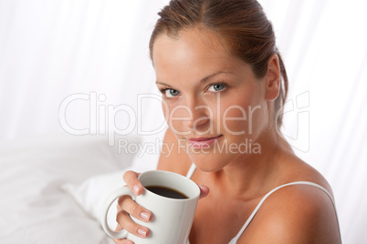 Beautiful young woman holding cup of coffee