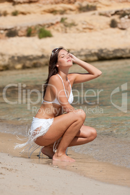 Young attractive woman on the beach