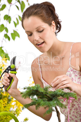 Gardening - woman cutting tree with pruning shears