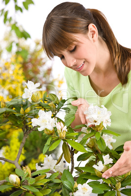 Gardening - Portrait of woman with Rhododendron flower