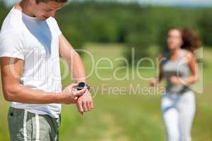 Young man with stopwatch measuring time