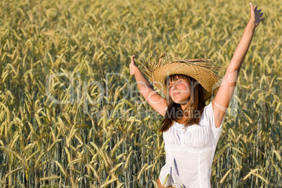 Happy woman with straw hat in corn field