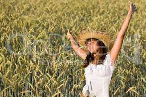 Happy woman with straw hat in corn field