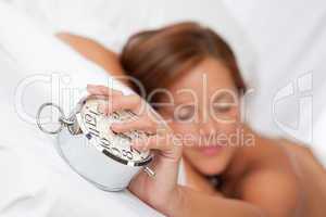 White lounge - Beautiful sleeping woman holding alarm clock