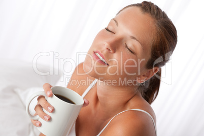 Beautiful young woman holding cup of coffee