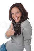 Happy young woman showing thumbs-up