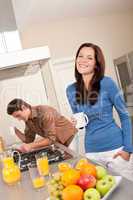 Smiling woman having coffee in the kitchen