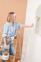Home improvement: Smiling woman with paint