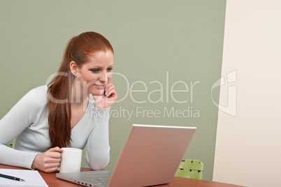 Long red hair woman working at office with coffee