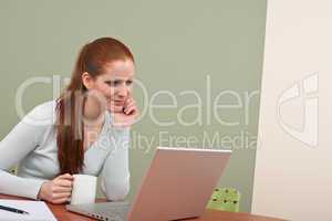 Long red hair woman working at office with coffee