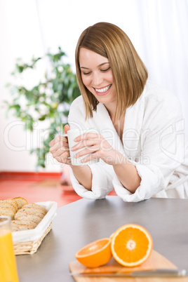 Breakfast - smiling woman with coffee in kitchen