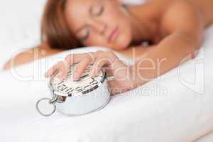 White lounge - Woman holding silver alarm clock
