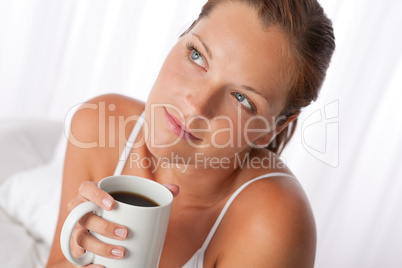 Beautiful young woman holding cup of coffee