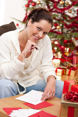 Attractive brunette writing Christmas cards