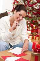Attractive brunette writing Christmas cards