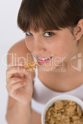 Female teenager eat healthy cereal for breakfast