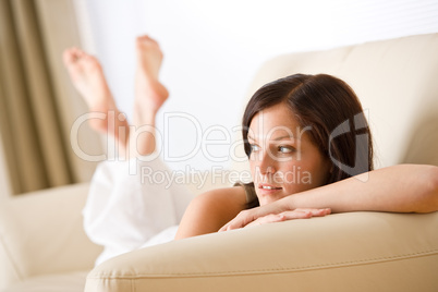 Thoughtful woman relax in lounge on sofa