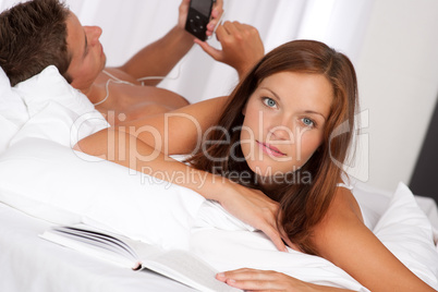Young couple lying down in bed
