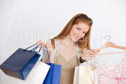 Fashion shopping - Happy woman with bag and dress