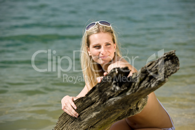 Beautiful woman enjoy summer sun at lakeside