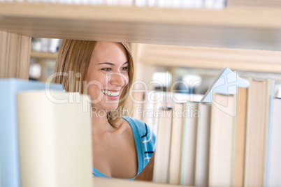 Student in library - cheerful woman read book