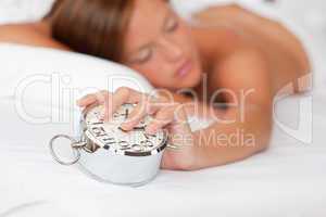 White lounge - Woman holding alarm clock and sleeping