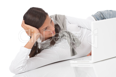 Teenager lying down with laptop