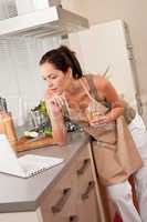 Woman with laptop in the kitchen